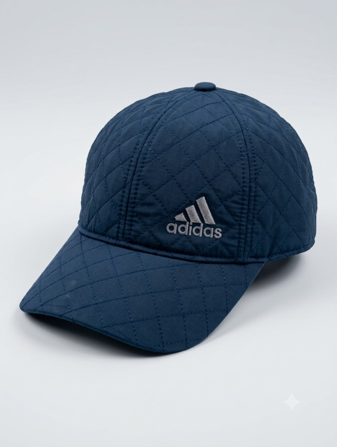 Navy blue quilted baseball cap with diamond stitching, product detail view